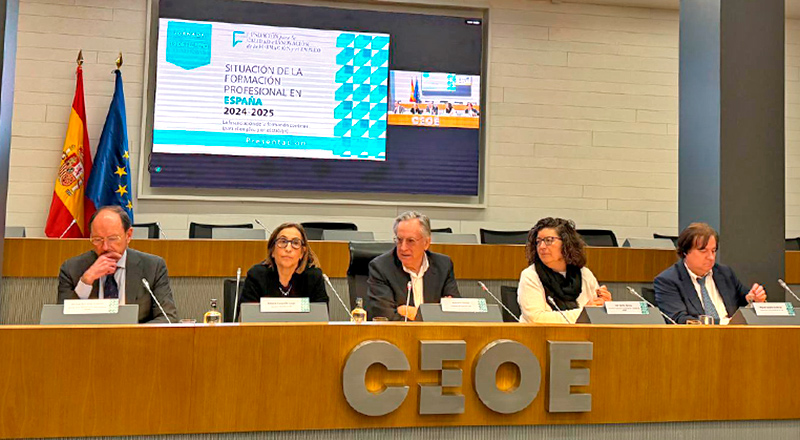 Varios ponentes en la presidencia de un auditorio con la bandera de españa y la unión europea con el logo de CEOE en el centro